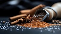 Aromatic ground coffee spills from metal scoop with star anise and cinnamon sticks on dark background, macro food photography with selective focus.