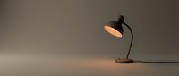 Vintage desk lamp with curved black metal arm and warm glowing shade on neutral background, suitable for interior design, office decor, and lighting product concepts.