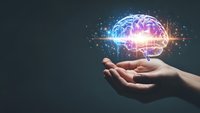 Human hand holding glowing brain with neural networks and light effects representing artificial intelligence, machine learning and cognitive technology concepts.