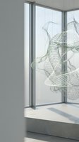 Modern minimalist interior with abstract wireframe sculpture suspended near large windows casting natural light shadows on concrete surface for contemporary design.
