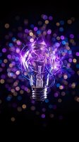 Glowing light bulb with purple electric energy and colorful bokeh lights on dark background for creative innovation and bright ideas concepts.