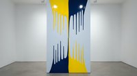 Modern abstract wall art with yellow and navy blue paint drips in contemporary gallery space for interior design and home decor projects.