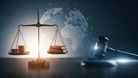 International law concept with scales of justice and gavel against world globe background for legal services and global jurisprudence applications.