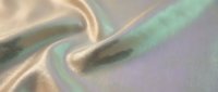 Iridescent holographic fabric with smooth flowing waves in pastel rainbow colors creating luxurious textile background for fashion and design projects.