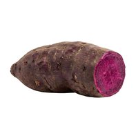 Whole and sliced purple sweet potato isolated on white background, showing vibrant magenta flesh and earthy skin for culinary and nutritional content.