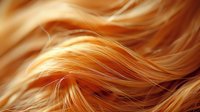 Golden blonde hair waves in soft flowing curves, creating a luxurious textured background for beauty and fashion concepts.