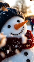 Close-up portrait of cheerful snowman with carrot nose, coal eyes and smile, wearing knit black hat and red scarf while snow falls in golden winter sunlight.