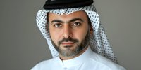 Middle Eastern man wearing traditional white ghutra headdress and black agal, dressed in white thobe, professional portrait against neutral background.