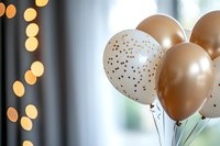 Elegant gold and white polka dot balloons with bokeh lights in background create festive party atmosphere for celebrations and special events.