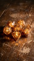 Golden translucent polyhedral dice set glowing with warm light on rustic wooden table surface for tabletop gaming and role-playing adventures.