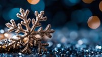 Glittering silver snowflake ornament with sparkling bokeh lights on dark blue background creates magical winter holiday atmosphere. Macro photography.