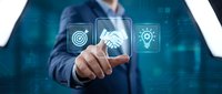 Businessman in blue suit touching digital interface with target, handshake, and lightbulb icons representing business strategy, partnership, and innovation solutions.
