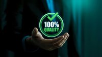 Businessman hand presenting glowing green 100% quality badge symbol for premium service guarantee and excellence standards in corporate environment.