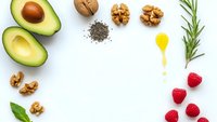 Healthy organic food ingredients arranged in circle frame on white background with copy space for nutritious meal planning and clean eating lifestyle.
