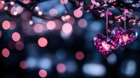 Pink glowing heart ornament hanging from branch with soft bokeh lights background creates romantic mood for Valentine's Day and love themes.