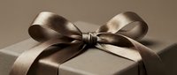 Elegant dark brown gift box with a luxurious satin ribbon bow on a neutral background, perfect for holiday, birthday, and luxury retail concepts.