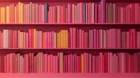 Rows of books arranged by color in shades of pink, red, and orange on wooden library shelves creating an aesthetic ombre gradient pattern.