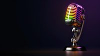 Vintage style microphone with rainbow colored metallic finish glowing in dark background on reflective surface, dramatic studio lighting creates nostalgic mood.