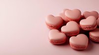 Heart shaped pink macarons arranged on pink background, sweet romantic French pastries with delicate texture and soft pastel colors for Valentine's day celebration.