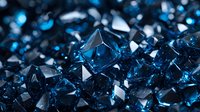 Macro shot of deep blue crystal formations with sharp geometric edges and facets creating abstract luxury background with dramatic lighting and reflections.