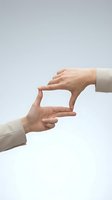 Two hands forming frame gesture on white background for creative vision and focus concepts in business and photography applications.