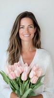 Smiling woman in white sweater holding fresh pink tulips bouquet against light background, natural beauty portrait showcasing spring flowers and feminine lifestyle.