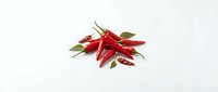 Fresh red chili peppers with green stems isolated on white background, ready for culinary, food packaging, and recipe design projects.