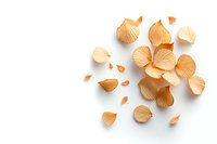 Delicate dried orange flower petals scattered on white background, creating soft natural composition with gentle shadows. Isolated botanical elements.