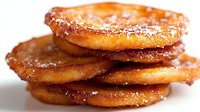 Stack of golden crispy potato pancakes with caramelized edges dusted with powdered sugar on white background isolated for culinary design projects.