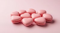Heart shaped pink macarons arranged on pink background, sweet romantic French pastries with delicate texture and soft shadows for Valentine's day or wedding design.