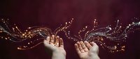 Open hands releasing magical golden light streams with sparkling particles against burgundy background for fantasy and spiritual concepts.