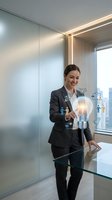 Professional businesswoman touching glowing lightbulb with digital innovation icons in modern office environment representing creative solutions and technology.