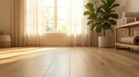 Bright, minimalist interior with wooden flooring, potted plant, and natural sunlight streaming through window. Suitable for home decor, real estate, and interior design projects.