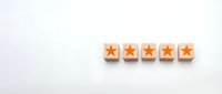 Five orange star rating blocks arranged in row on clean white background for customer feedback and review systems.