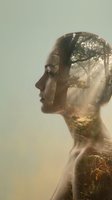Woman with serene expression in profile, double exposure featuring misty forest landscape within silhouette, warm golden tones, nature connection concept for wellness, mindfulness, mental health awareness.