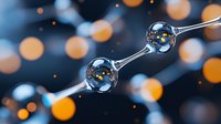 Macro photography of water drops on thin branch with golden bokeh lights in background creating magical atmosphere. Reflections show blurred lights.