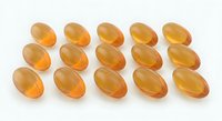 Golden omega-3 fish oil capsules arranged in rows on white background for health and wellness supplement marketing materials.