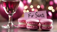 Pink macarons with note for Santa and wine glass against festive bokeh background, creating magical holiday atmosphere with soft glowing lights.