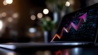 Glowing financial chart with upward trend on laptop screen against blurred bokeh background, showing market growth and business analytics.
