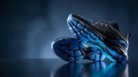 Modern athletic running shoes with blue LED lights glowing in dark studio setting for sports and fitness marketing campaigns.