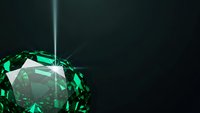 Sparkling emerald green diamond gemstone with brilliant faceted cuts reflecting light beams on dark background for luxury jewelry design and precious stone concepts.