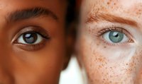Close up comparison of two eyes with contrasting features - one with dark brown iris and smooth skin, other with light blue iris and prominent freckles, showing diversity and beauty.