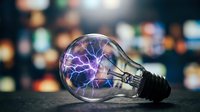 Young adult male, Caucasian, scientist or innovator, holding glowing lightbulb with purple electrical energy inside against blurred city lights background. Represents creativity, innovation, and bright ideas for business and technology concepts.