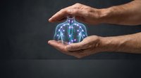 Male hands cradling glowing blue holographic human lungs with respiratory system visualization against dark background for healthcare and medical concepts.
