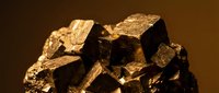 Golden pyrite mineral specimen with metallic cubic crystals and natural geometric formations for geology education and mineral collection displays.