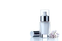 Elegant glass cosmetic bottle with silver pump dispenser and delicate pink flowers on white background, luxury skincare product presentation for beauty industry.