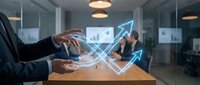 Business professional analyzing digital growth data with glowing arrow graphics in modern office meeting room for financial success presentations.