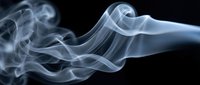 Elegant white and blue smoke swirls rising against a dark black background, creating abstract flowing curves and soft wispy textures.