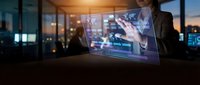 Professional businessman analyzing financial data on transparent holographic display in modern office environment during evening hours.