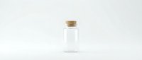 Empty glass bottle with cork stopper on white background, minimalist laboratory container for cosmetics, medicine or essential oils storage.